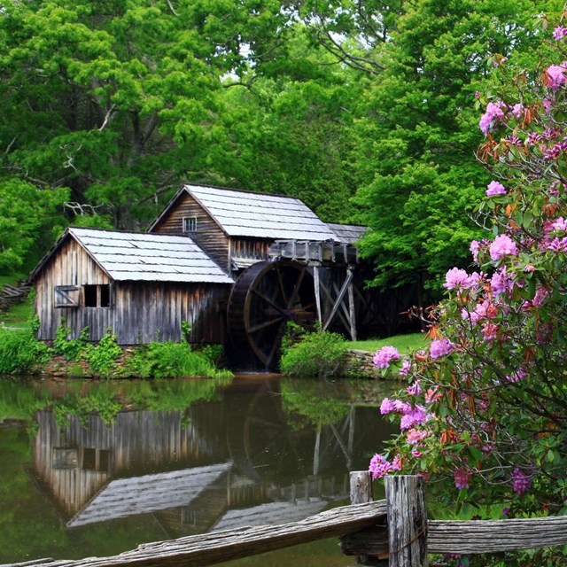 Old-fashioned mill with reflection in water.