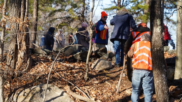 Group of people walking up a steep incline