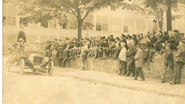 Photo of workers from the Draper Corporation listening to speaker in the back of car. 1913 Strike