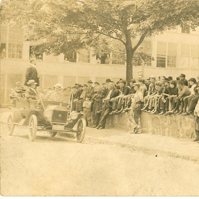 Photo of Draper Corporation workers listening to speaker in back of car. 1913 Strike