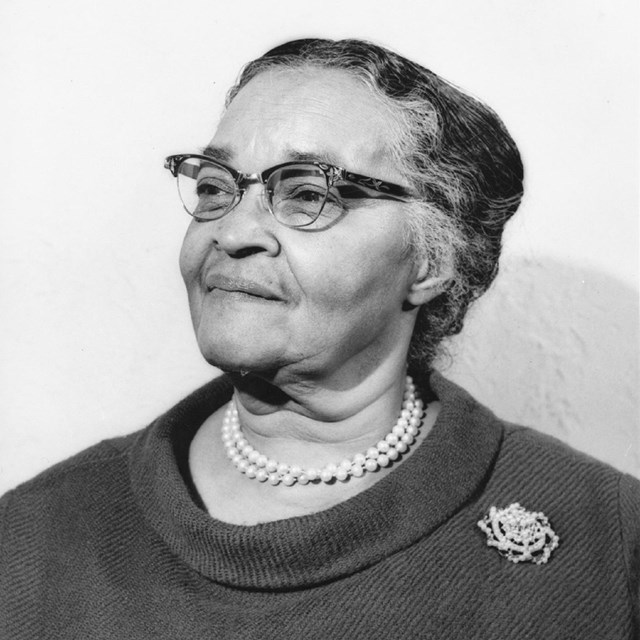 Black and white portrait of a middle-aged Black woman (Dr. Melnea Cass) wearing glasses. 
