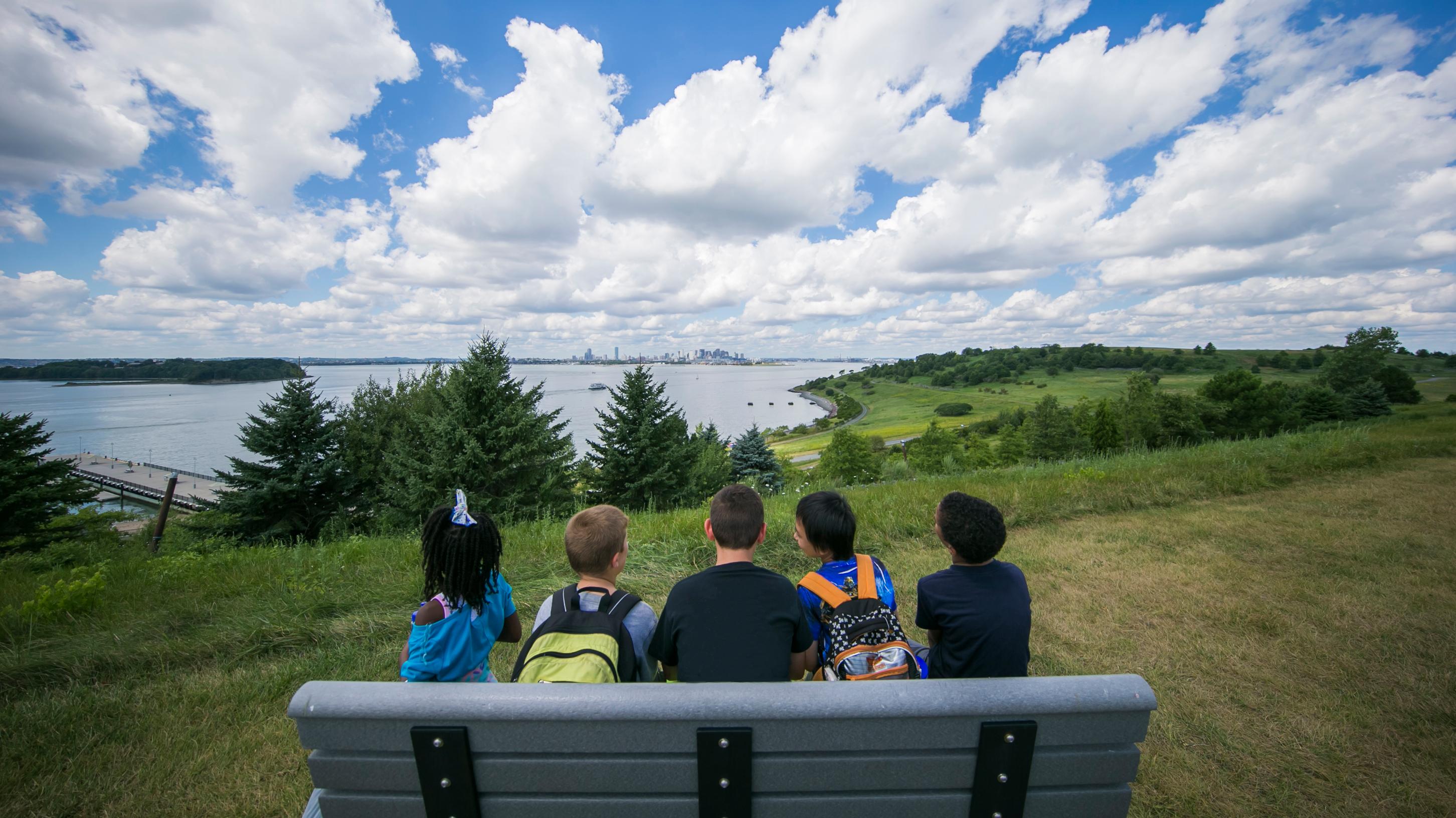 Children looking back at the city from the Boston Harbor Islands