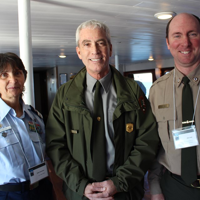 Coast Guard, National Park Service, and State Park Service employees stand together.