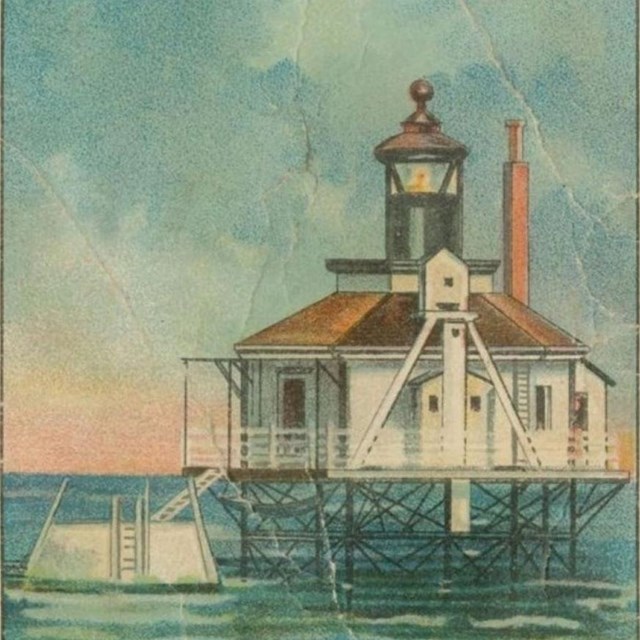 A colored postcard showing a white and brown lighthouse on metal frame above calm water