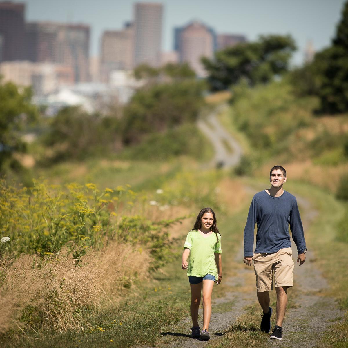 two people walking on a trail on Spectacle Island