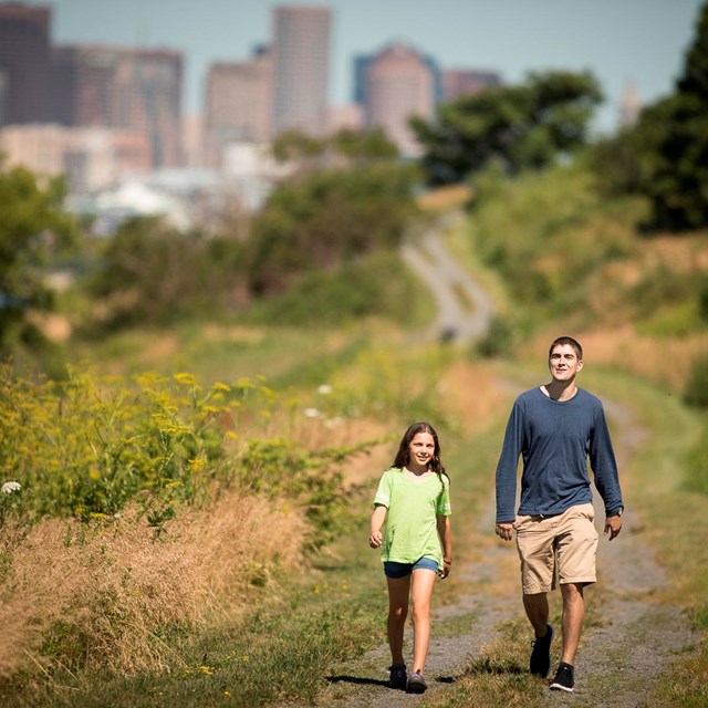 two people walking on a trail on Spectacle Island