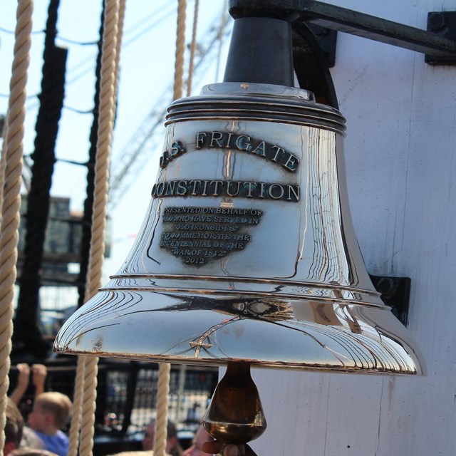 The bell of USS CONSTITUTION that states USS Frigate CONSTITUTION.