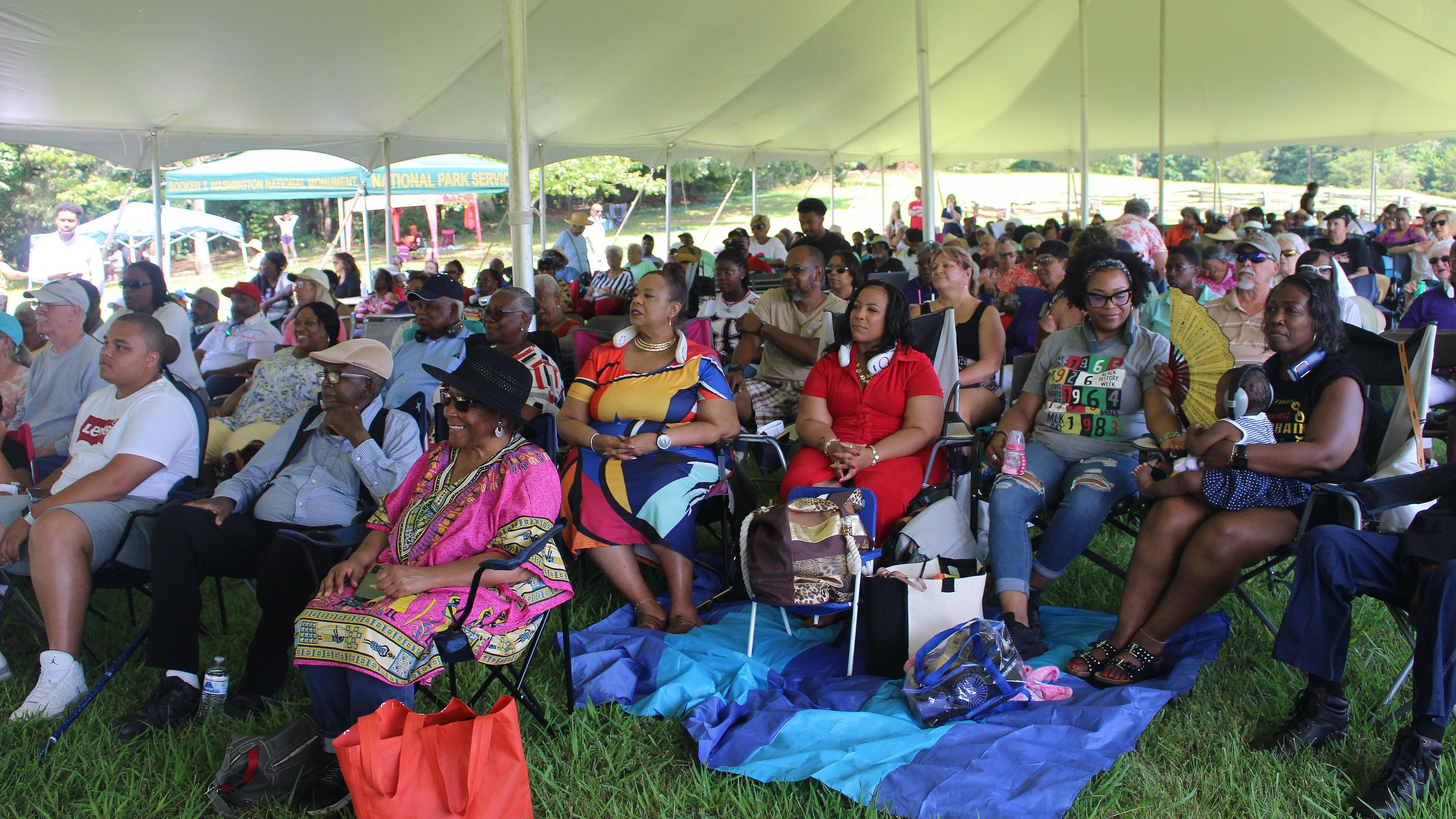 A group of spectators sits and enjoys the annual Juneteenth concert series.