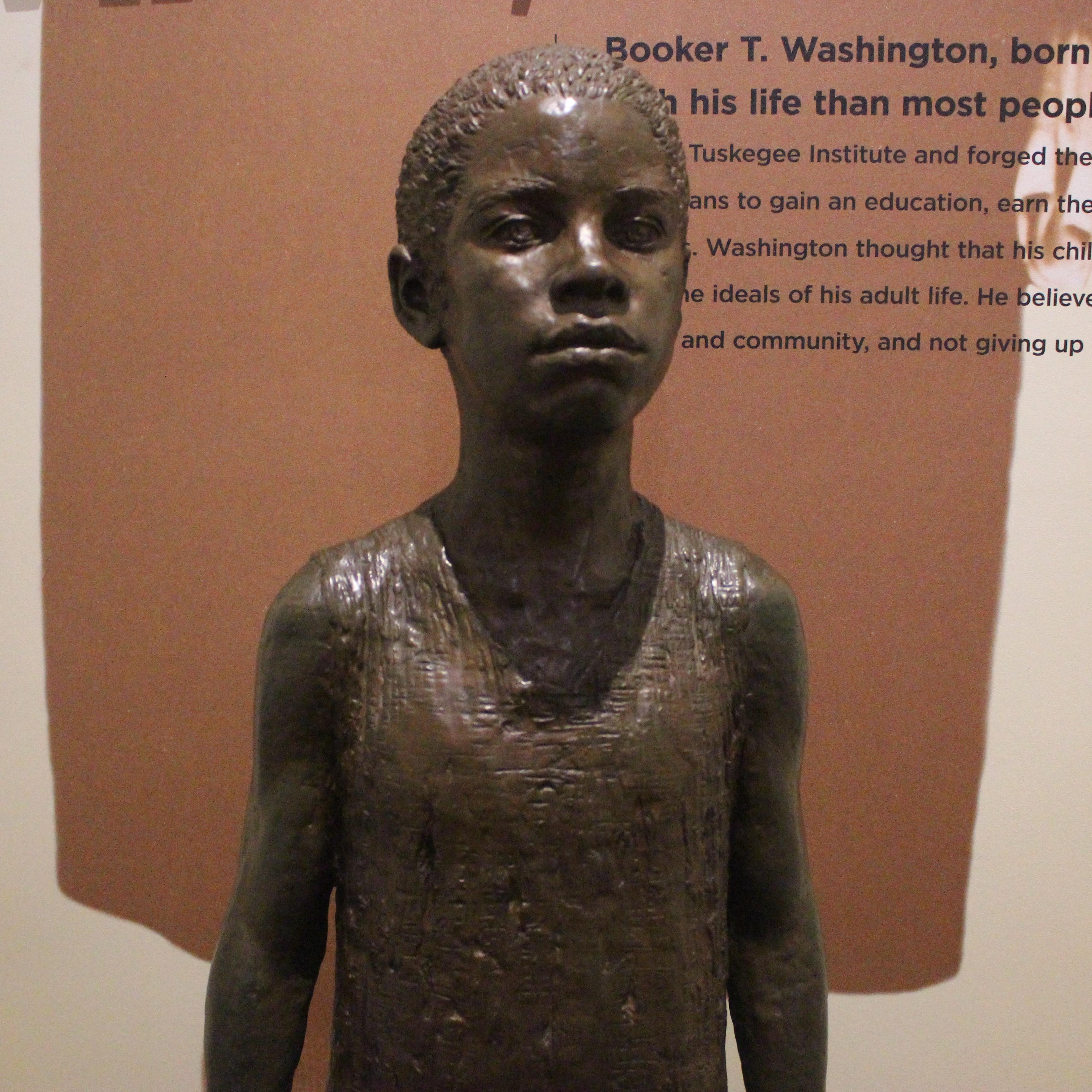 A statue of young Booker T. Washington