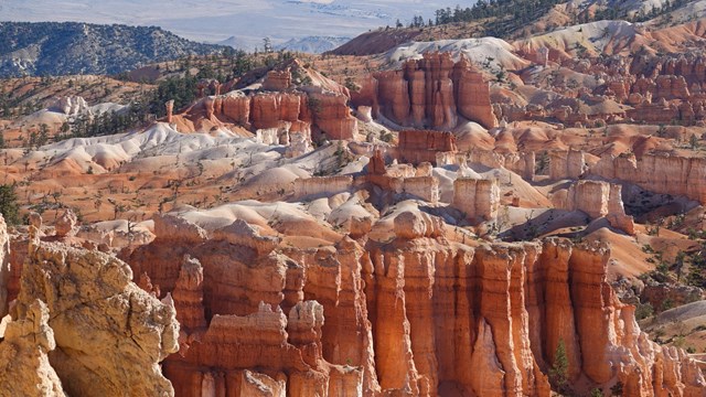Irregular red rock formations in various shades of orange, pink and white.