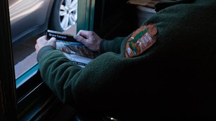 Park Ranger holds Map and Guide at Entrance Station