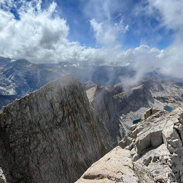 Sharp rocky mountain peaks in wispy clouds