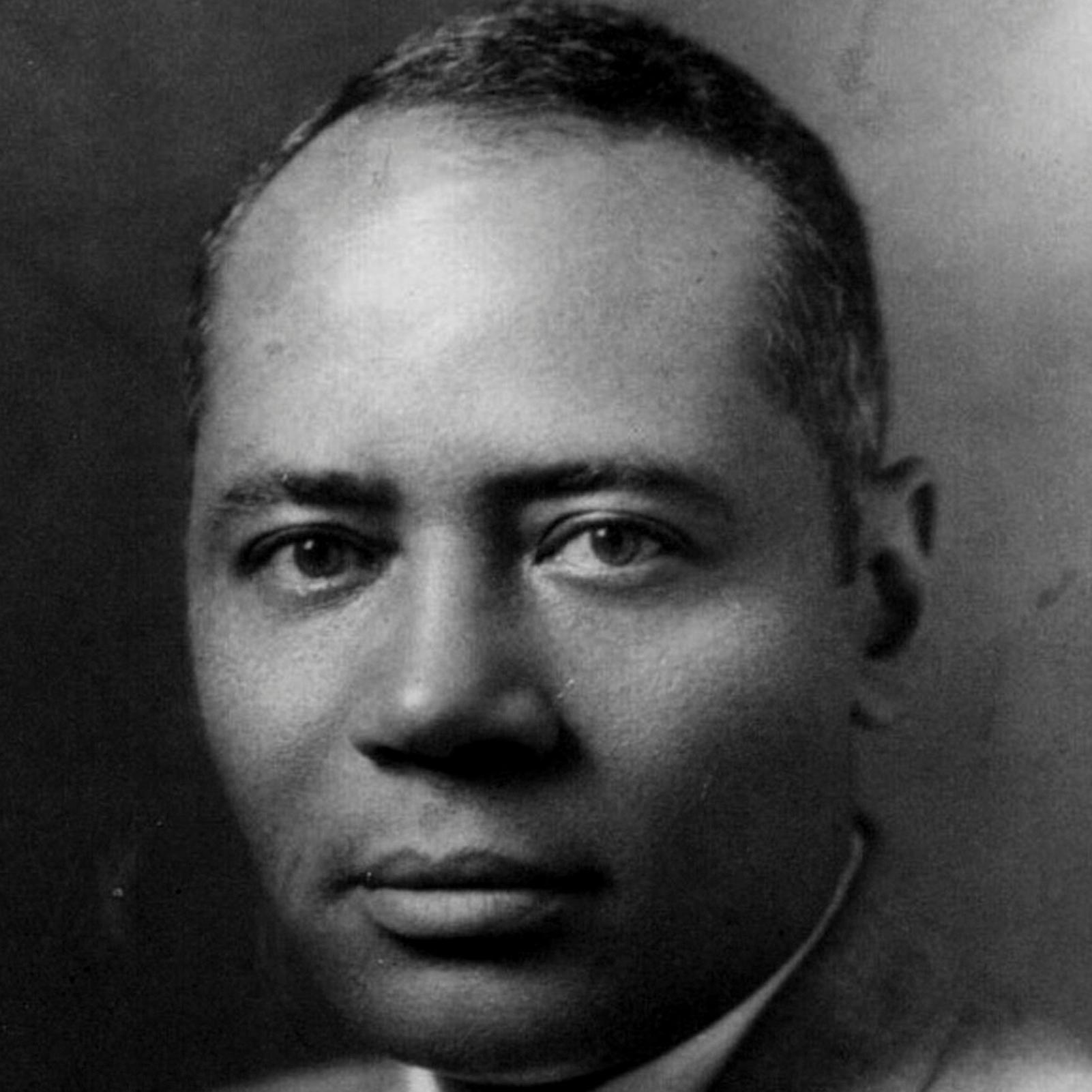 Charles Hamilton Houston poses for a head and shoulders portrait in a grey suit.