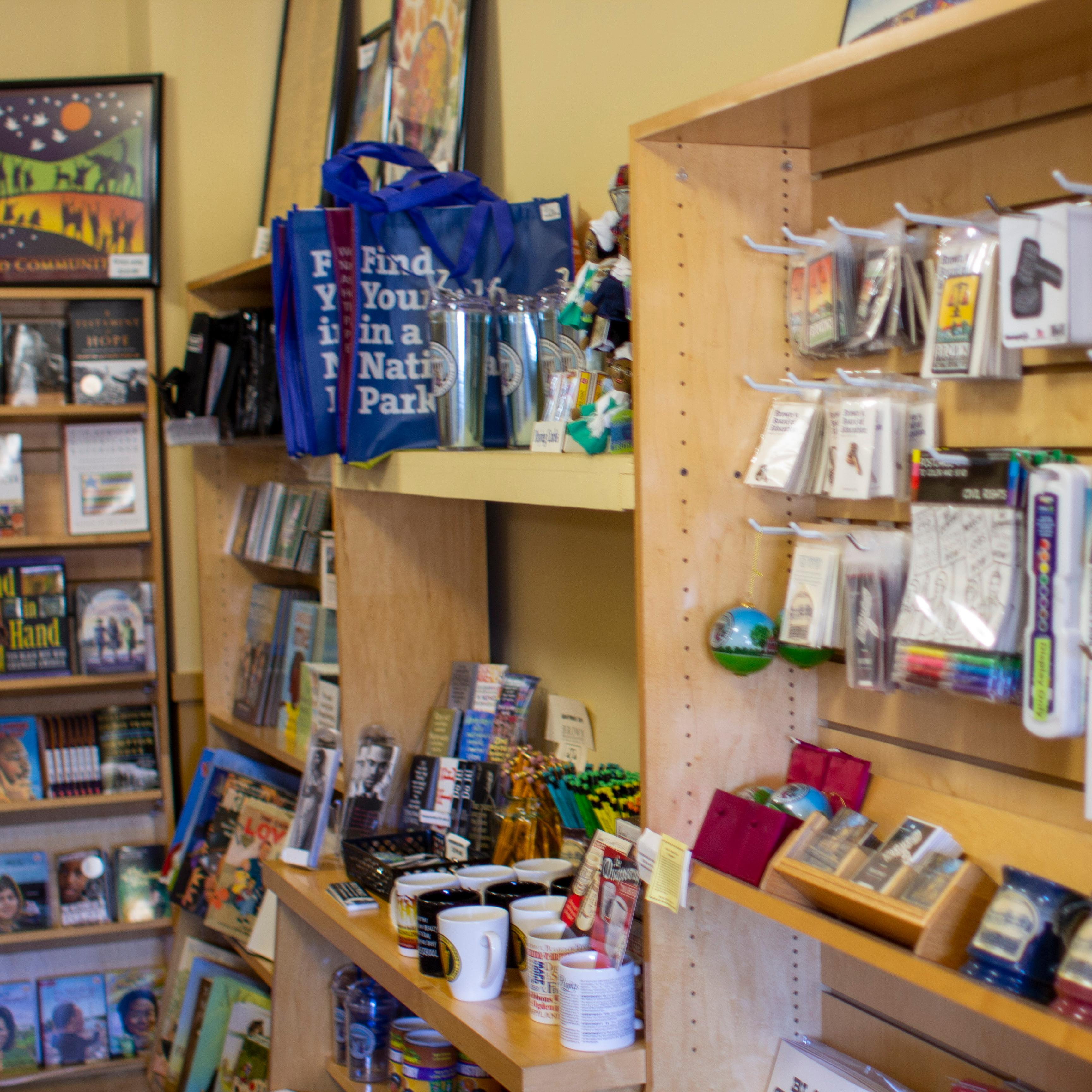 Books, Mugs, Postcards, Shirts, Bags, Patches, Coins, and much more are available for purchase.