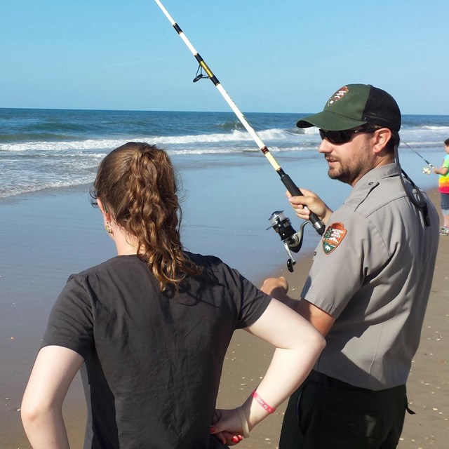 Ranger with visitor and fishing pole