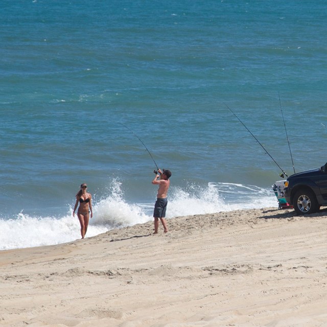 Two ORVs with beachgoers