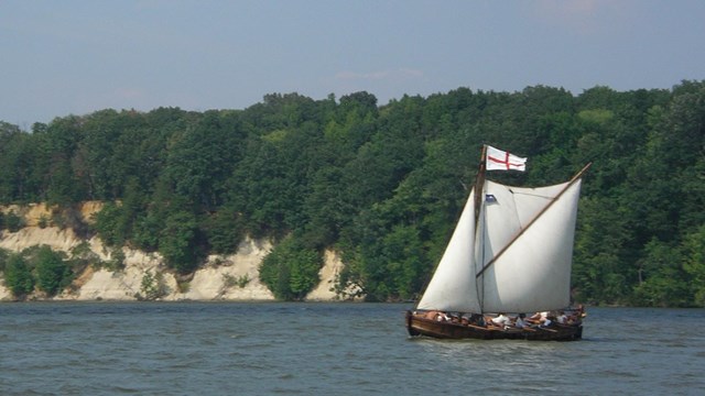 A European style sailing ship on a river. 