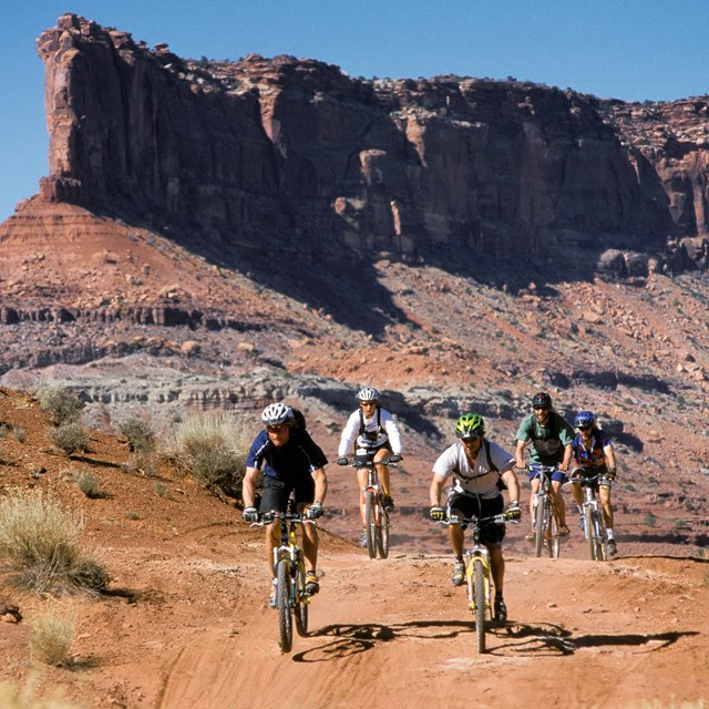 bicyclists riding on a gravel road