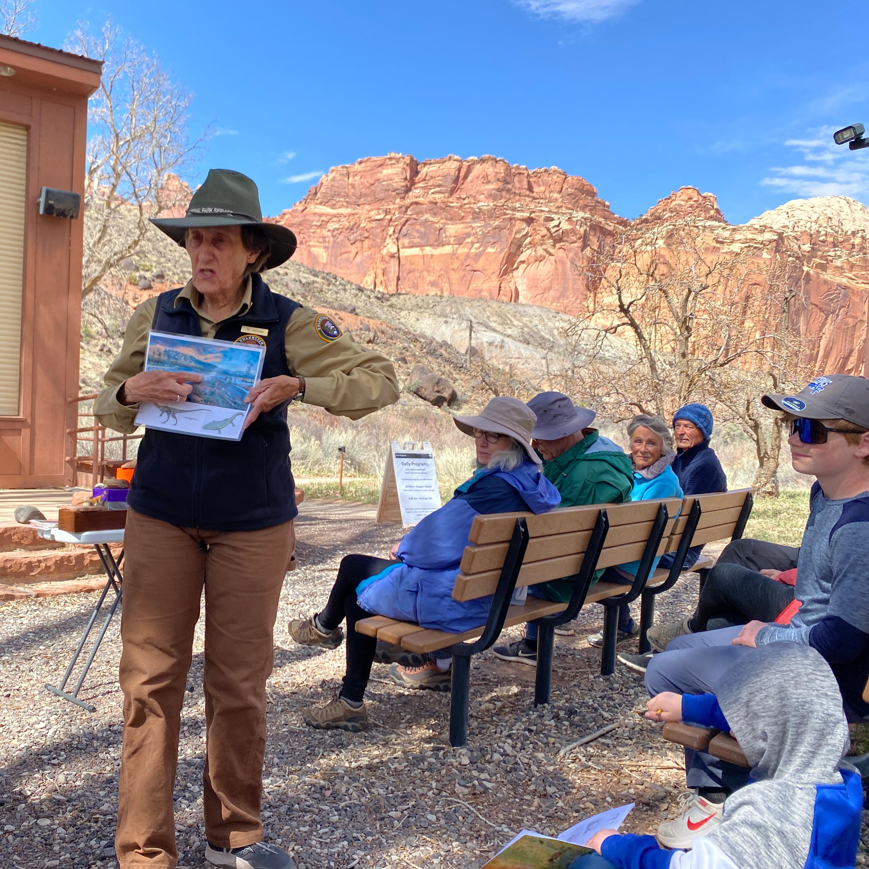 A volunteer stands and speaks to an audience