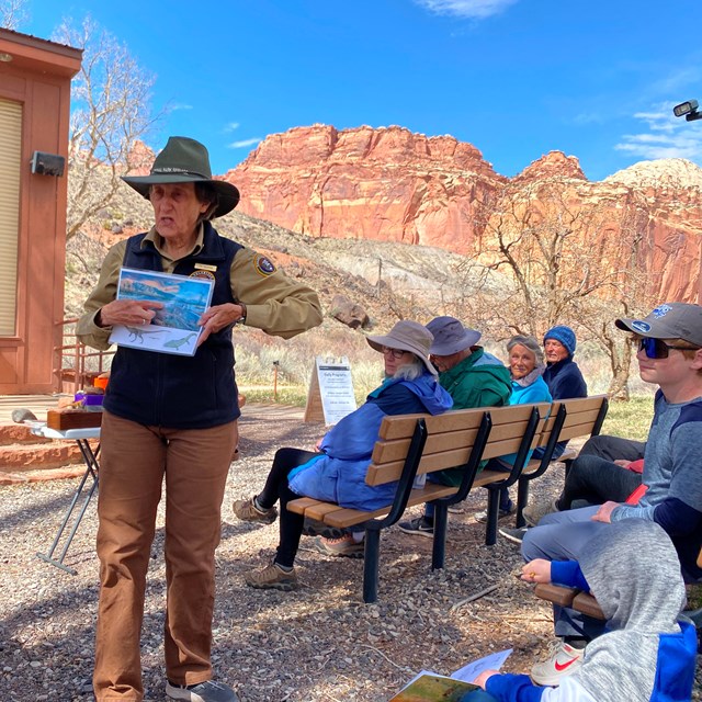 A volunteer stands and speaks to an audience