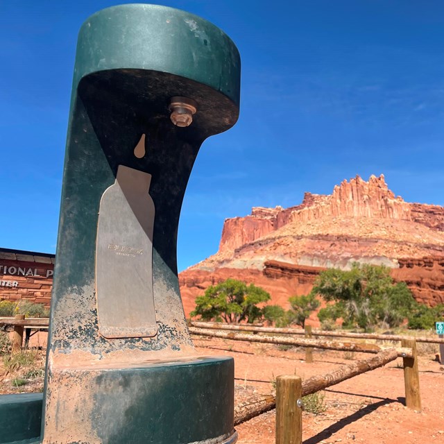 a water bottle filling station is used to refill a water bottle