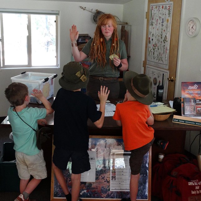 Volunteer saying Junior Ranger pledge with three children and an adult.