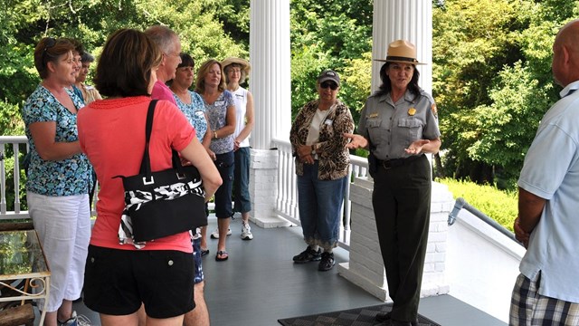 A group of adults on a house tour with a park ranger