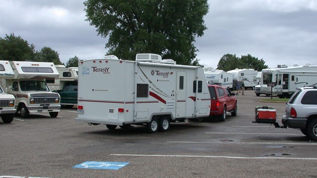 22 RVs in a visitor center parking lot 