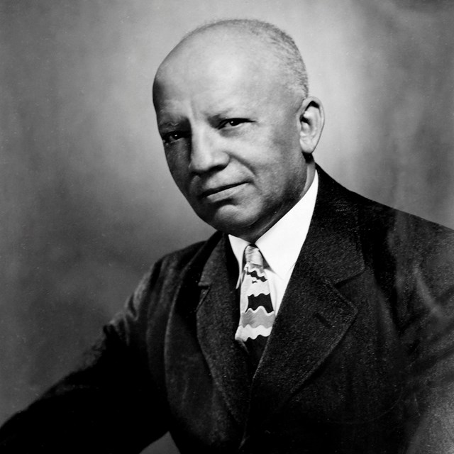 A black-and-white portrait of Carter G. Woodson