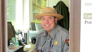 Male park ranger smiling.