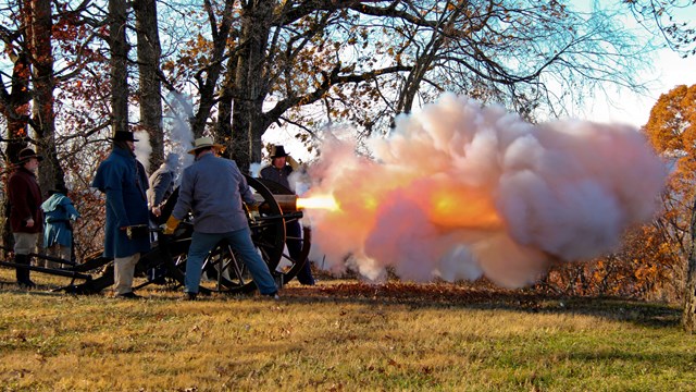 Living historians fire a reproduction cannon