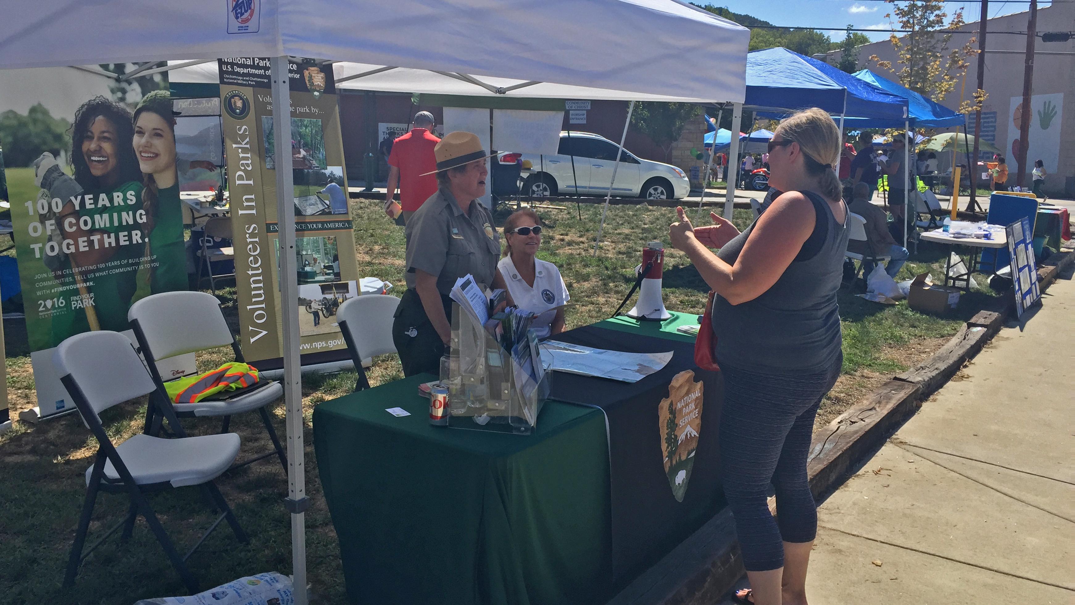 Park ranger greets visitors at a public event