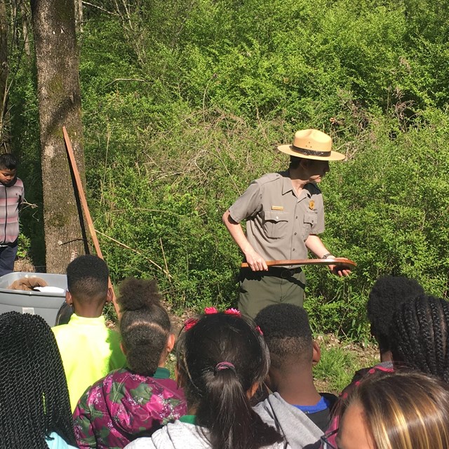 A ranger talks to a group of Students