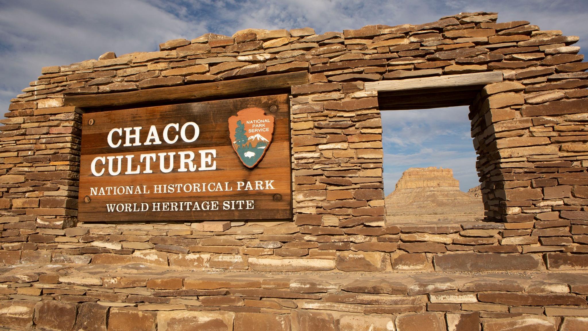 The entrance sign to Chaco Culture National Historical Park and Fajada Butte in the background.