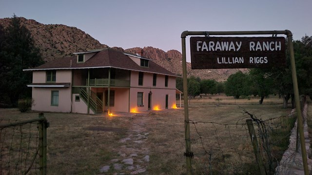 Pink house with trees and mountains; sign in forefront reading Faraway Ranch Lillian Riggs