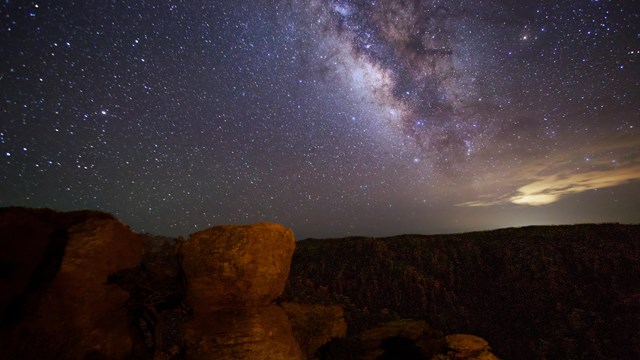 rocks faintly show with bright milky way behind