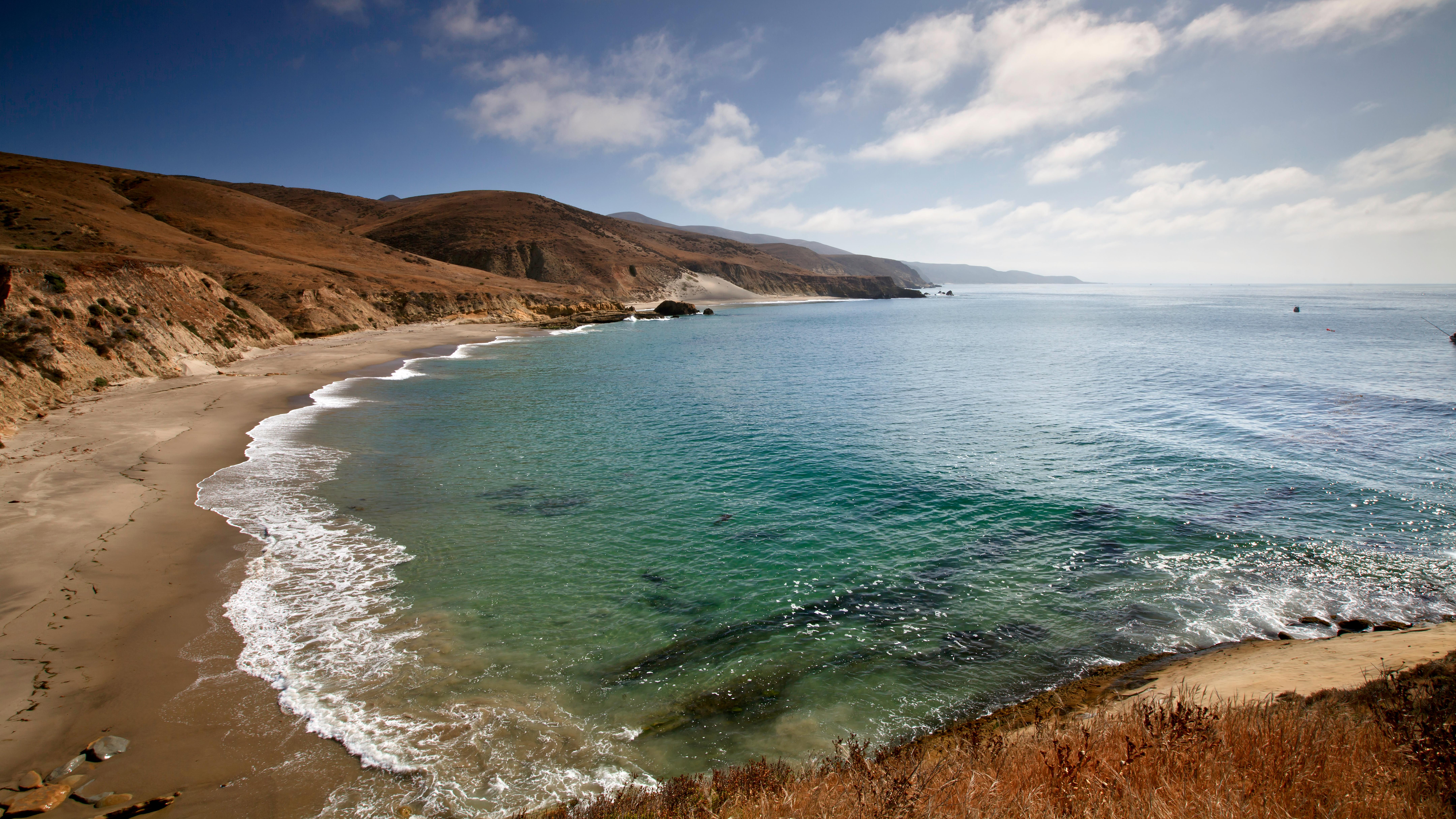 Crescent shaped harbor with sandy beach and blue water. &copy;Tim Hauf, timhaufphotography.com