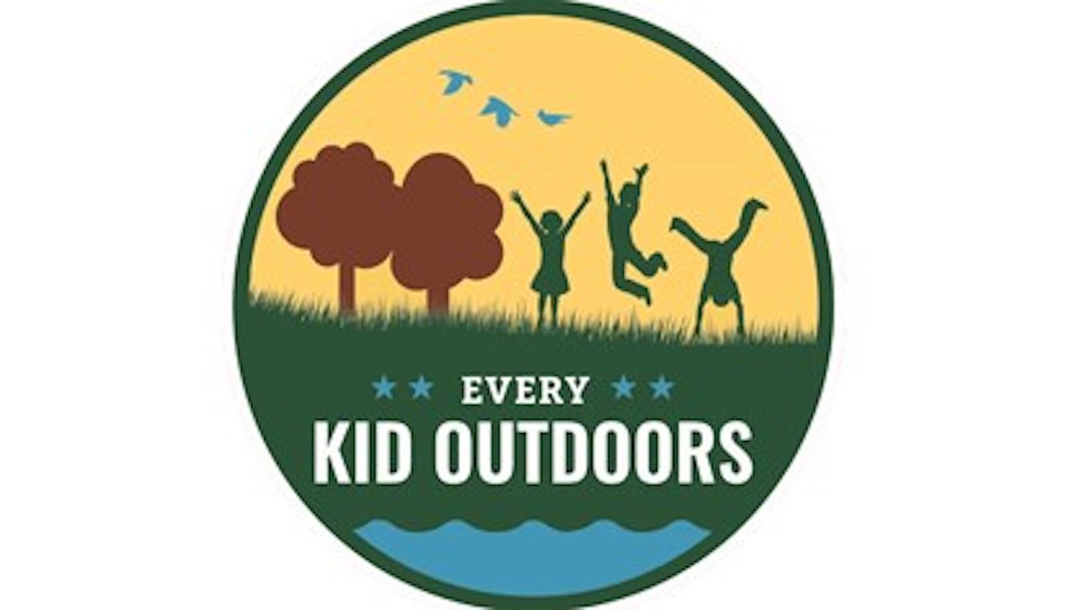 Logo of a landscape with water, grass, two trees, three birds, and three children playing.