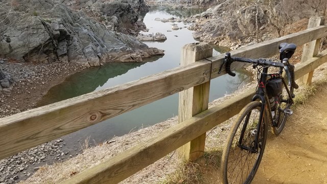 Bicycle against fence overlooking Great Falls.