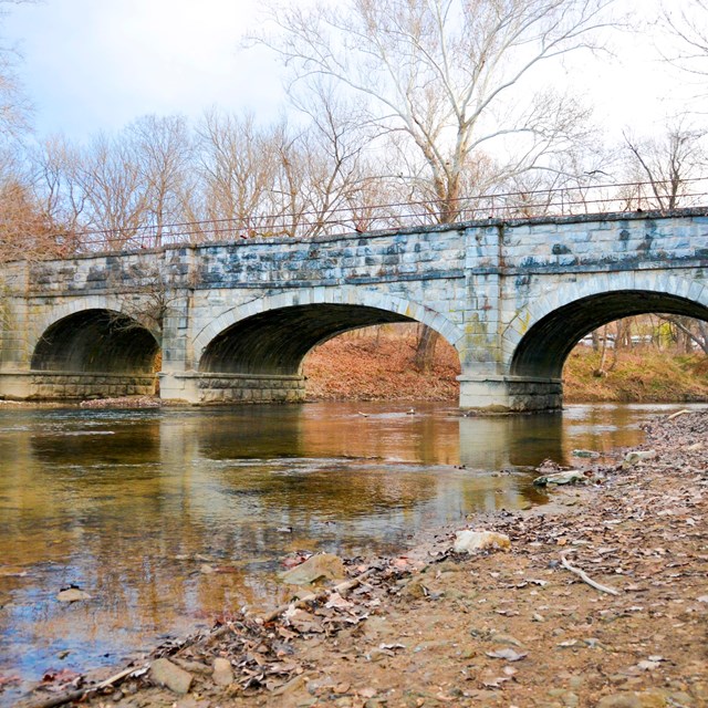 An aqueduct with three arches spans the Antietam Creek