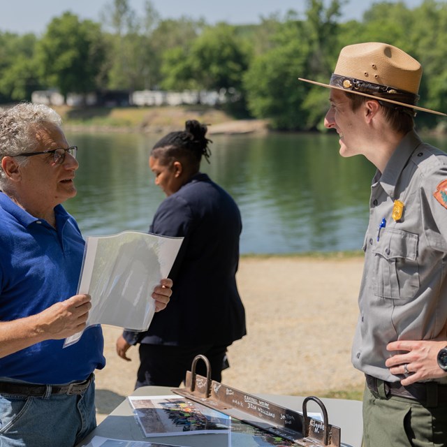Ranger and visitor conversing.