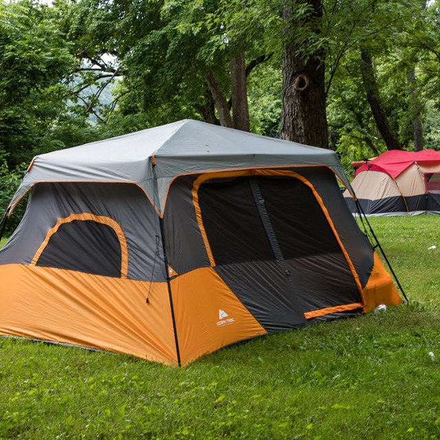 Orange and gray tent in a campground
