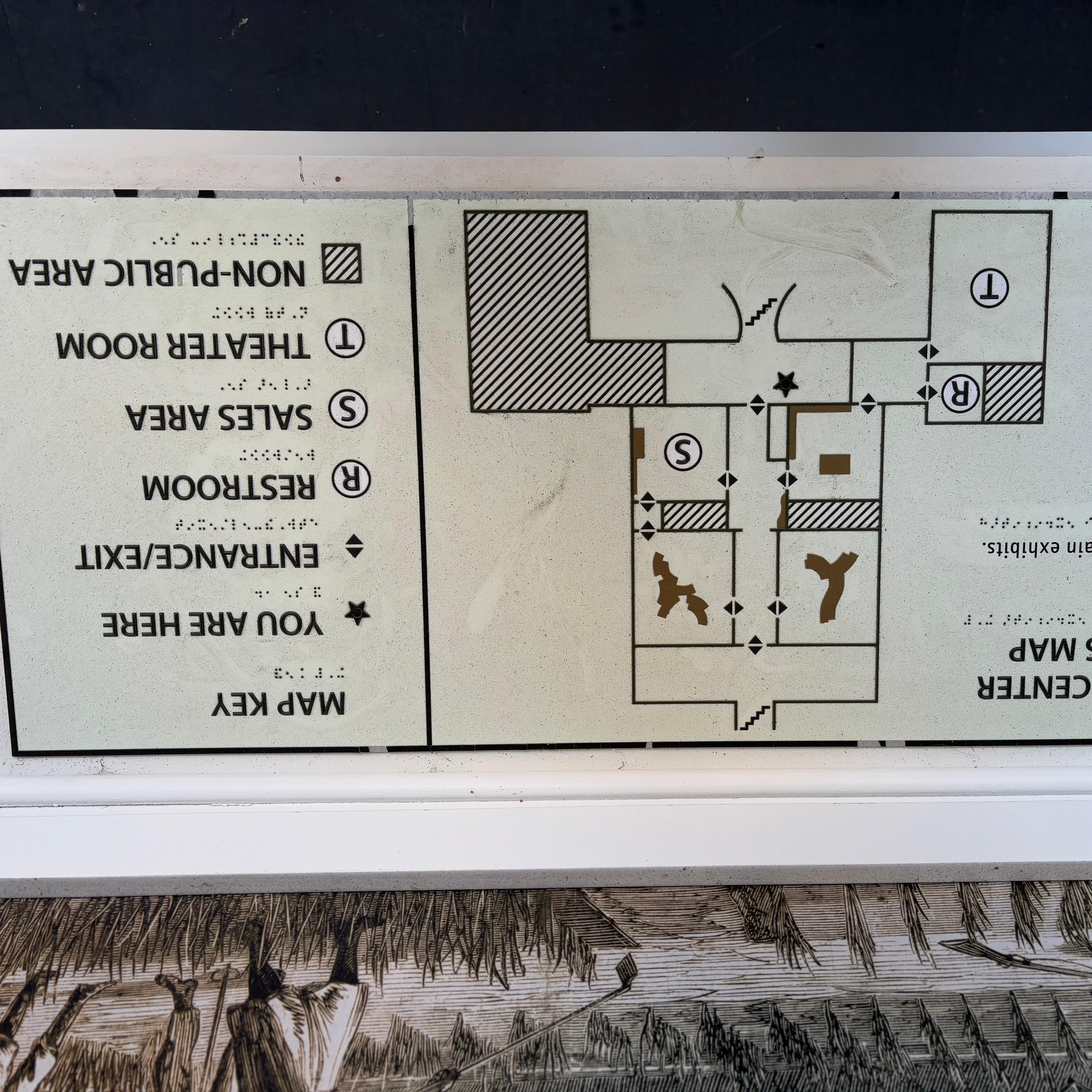 Tactile map with the floor plan of a house with exhibits, a restroom, and theater marked.