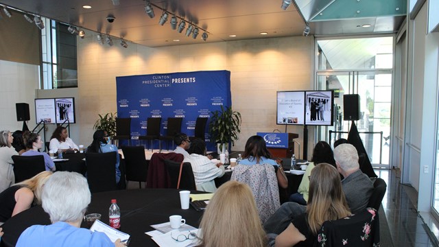 Audience at Clinton Presidential Center watching presentation on Brown v. Board of Education, 1954.