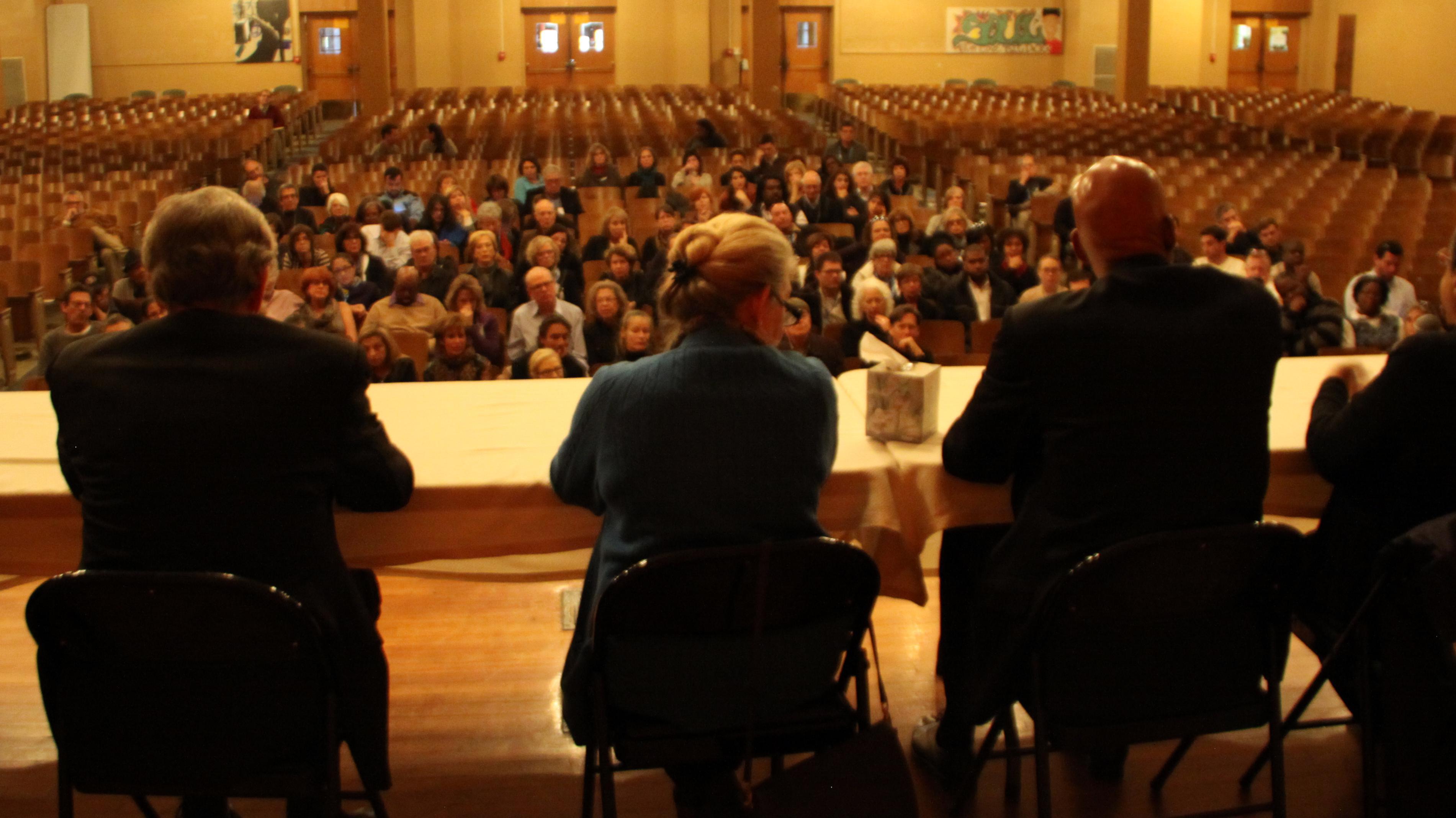 A panel discusses the story of Central High inside the school's cavernous auditorium.