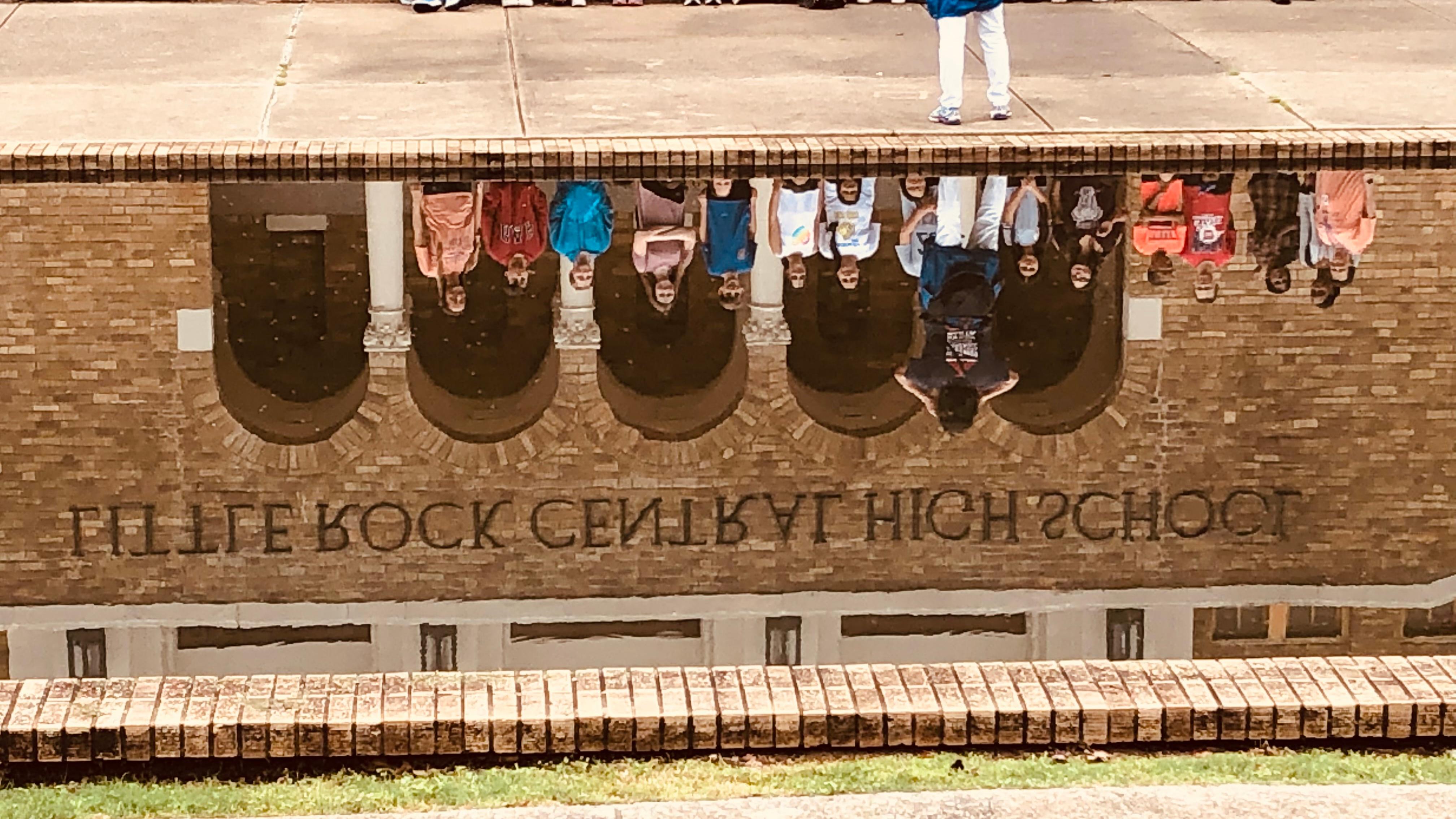 Reflections on visitors show in the Central High School reflecting pool.