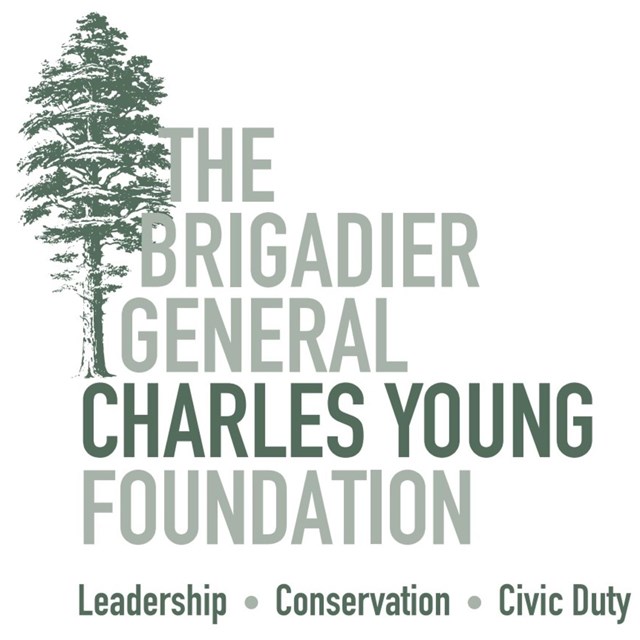 Text spelled out showing The Brigadier General Charles Young Foundation next to a tall vertical tree