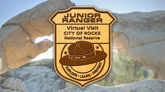 wooden junior ranger badge with a granite formation in the background.