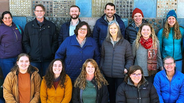 Photo of several smiling people standing together