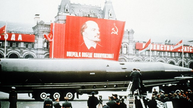 A Soviet SSN-8 intercontinental ballistic missile is displayed beneath a picture of Lenin